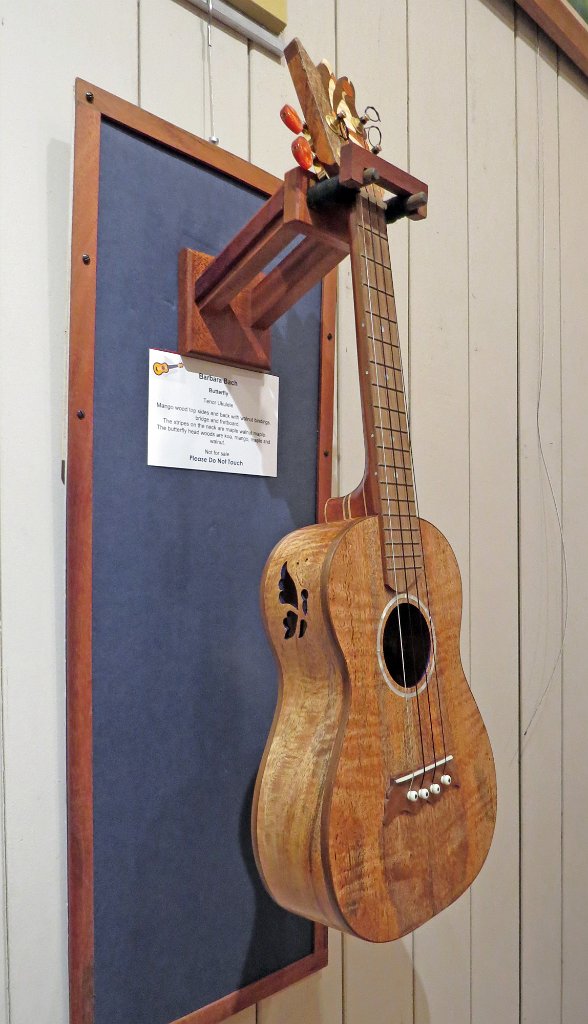 12 - Barbara Bach's all mango tenor ukulele with walnut binding, bridge and fretboard. Butterfly headstock is koa, mango, maple and walnut