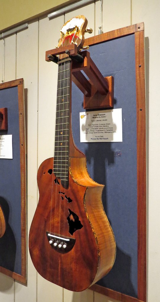 22 - Jane Klassen's curly koa tenor cutaway with gold tortoise shell binding and Hawaiian islands sound holes. Ebony bridge, fretboard and headstock with hand-cut volcano inlay