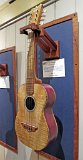 10 - Barbara Bach's purpleheart and mango tenor ukulele. Curly koa binding. Headstock is koa and quilted maple with plumeria blossoms of paua shell inlay