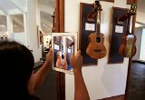 A visitor photographs an ukulele display.jpg