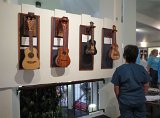 A visitor takes a look at Michael Perdue's ukuleles.jpg