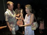 Dave Stokes presents an ukulele to winner Laura Richman of Kea'au.jpg
