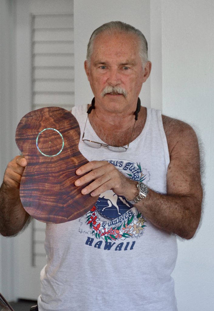 Tom Mullen holds an ukulele face