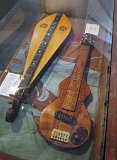08 Bob Gleason's curly koa lap steel guitar (L) and Carlos Newcomb's East Indian rosewood and Sitka spruce dulcimer