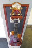 21 Jane Klassen's curly koa cutaway tenor ukulele with volcano theme headstock and Hawaiian islands soundholes