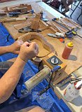03 Sam Rosen clamps a freshly bent ukulele side into a mold