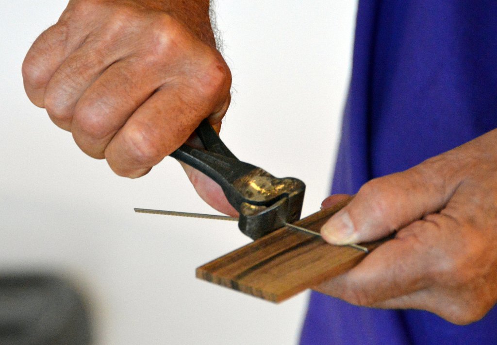 08 Gary Cassel trims a fretwire after installing it on the fretboard