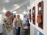 2014 Big Island Ukulele Guild exhibit 02  BIUG members Doug Powdrell (left) and Larrry Montero take a look at entries in the 2014 BIUG exhibit at Wailoa Center in Hilo