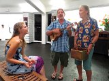 2014 Big Island Ukulele Guild exhibit 14  Ukulele raffle winner Daniel O’Connor plays a tune for Le’a Gleason (left) and her mother Anne Gleason during the 2014 BIUG exhibit at Wailoa Center in Hilo. Hilo Guitars and Ukuleles donated the ukulele.