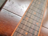Lewis Draxlir's hand-made wood fretboard markers using aluminum tubing as a cutter