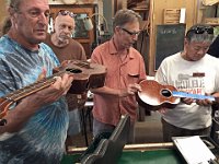 13 - Bob Gleason holds his all milo ukulele as bravely passes around two ukueles he is working on. Sam Rosen, Colin Alder and Tad Humble line up for a look