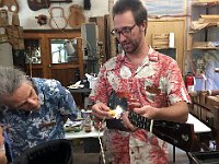 19 - Devon Rogers lights up the inside of a handcrafted ukulele as Bob Gleason steals a look